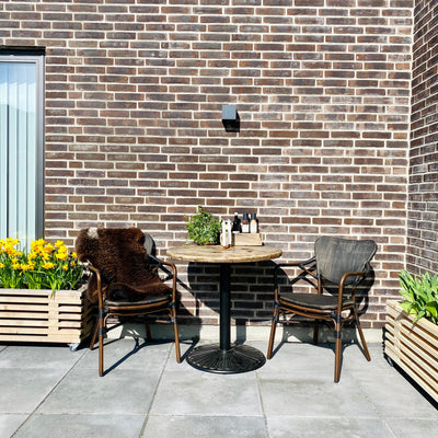 to havestole omkring et lille cafebord bed planter i baggrunden